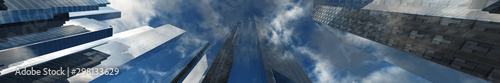 Skyscrapers against the sky with clouds. Modern buildings bottom view  3D rendering.
