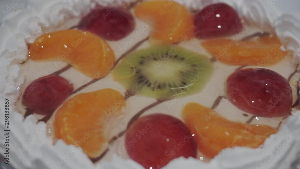 confection.round sponge cake decorated with fruits that rotates slowly.close-up.sweet moving background for your design confection.round sponge cake decorated with fruits that rotates slowly.close-up.sweet moving background for your design