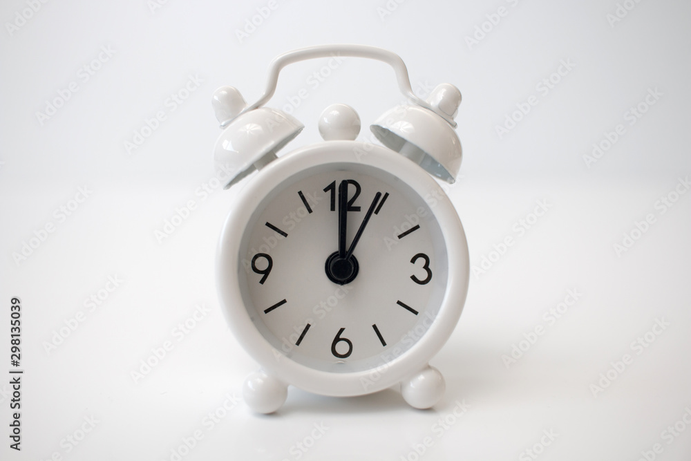 Closeup of a small clock showing the time 12 o'clock. Happy new year! Closeup of a small clock showing the time 12 o'clock. Happy new year!