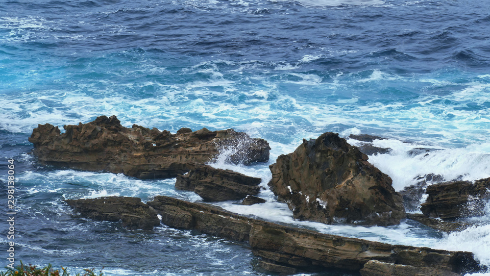 Fototapeta premium Coast of the sea with waves crashing on the rocks