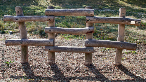 wooden fence built of large round logs on a sunny day