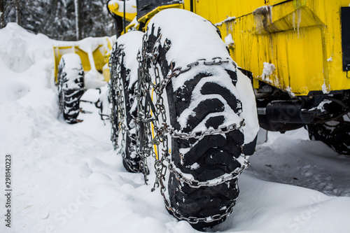 Snow chain on a large wheel in the snow