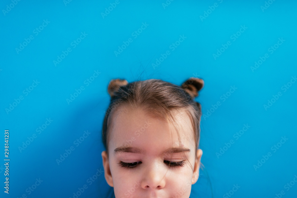 Portrait of a girl in front of a blue background Portrait of a girl in front of a blue background