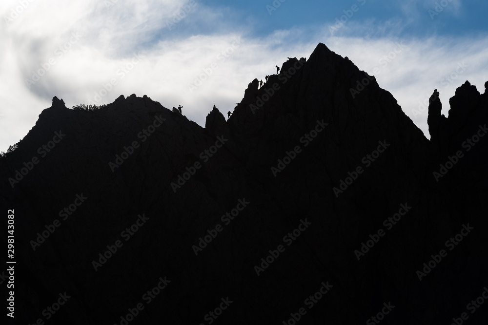 Silhouette of the alpinists climbing on the mountain ridge Zeleniske spice in the Kamnik-Savinja Alps, Slovenia Silhouette of the alpinists climbing on the mountain ridge Zeleniske spice in the Kamnik-Savinja Alps, Slovenia