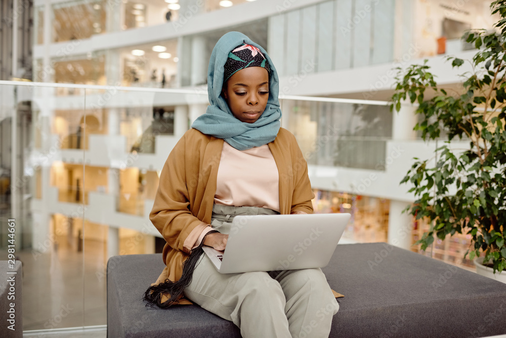 © Clique Images/Stocksy - African Muslim Woman Working in Business Center