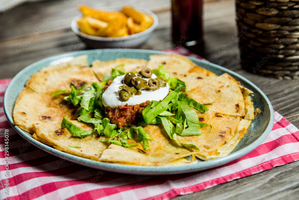 tortilla with tomato sauce, olives and sour cream tortilla with tomato sauce, olives and sour cream