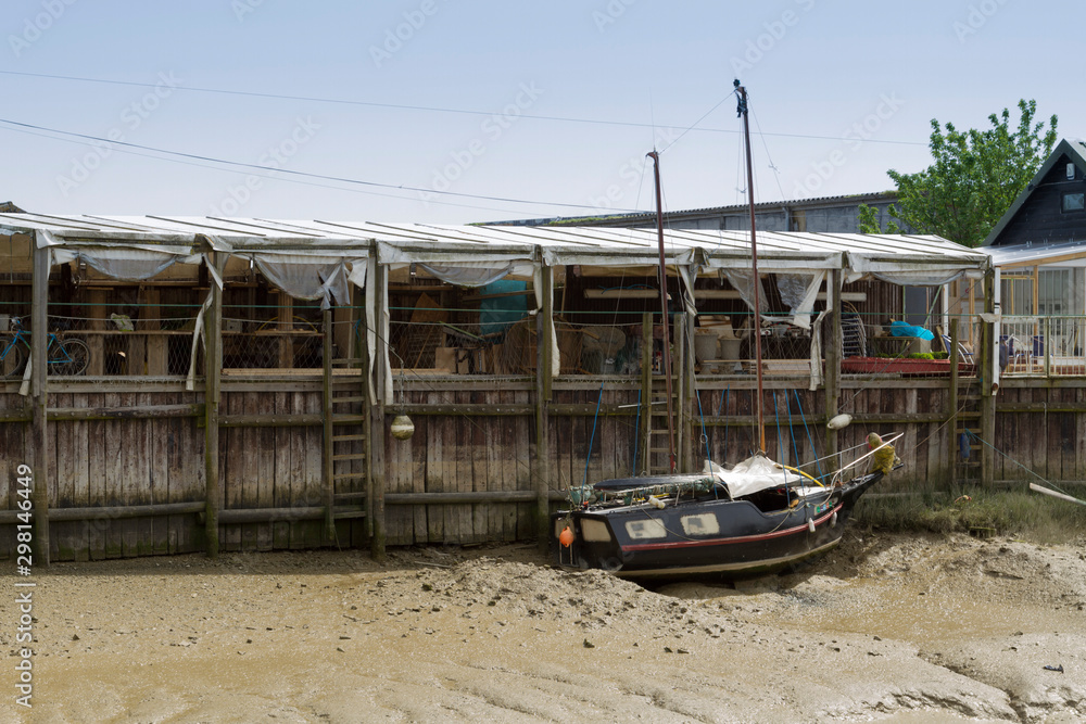old boat moored by riverside with the tide out old boat moored by riverside with the tide out