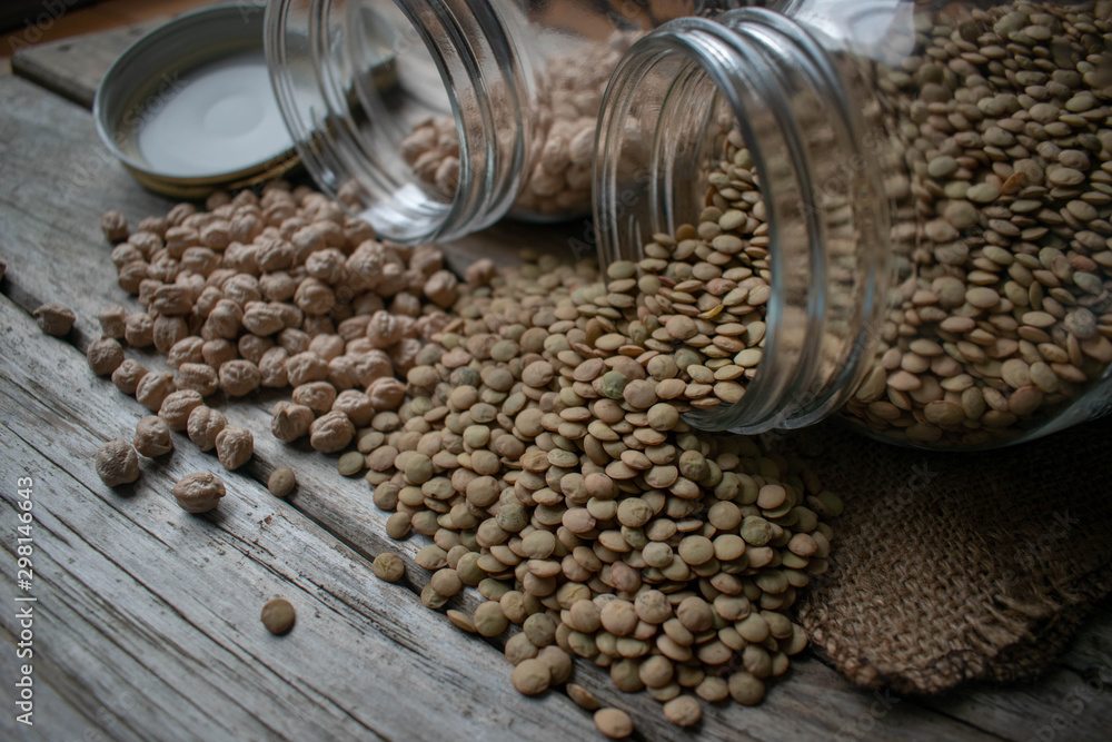 Legumes jar, chickpeas and lentils on wooden background. Legumes jar, chickpeas and lentils on wooden background.