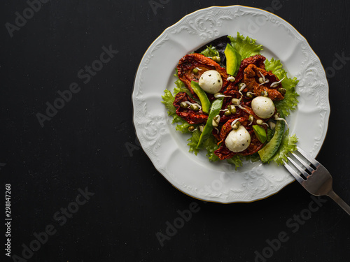 salad made from dried tomatoes  pe-tsai  avocado  and mozzarella cheese. close-up.