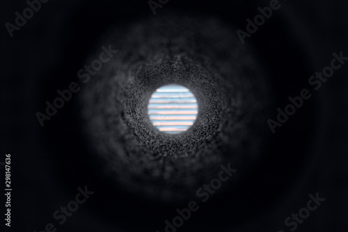 View through vent hole in concrete wall photo