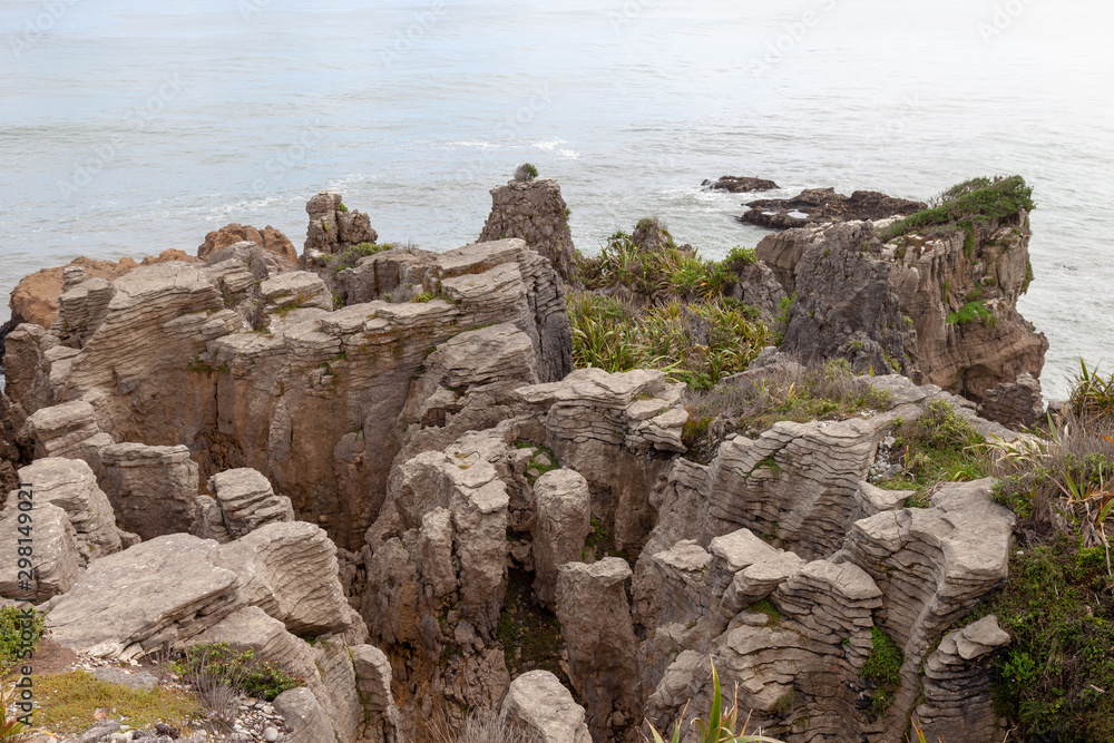 Pancake Rocks in Punakaiki, New Zealand. Limestone formation overlooking the ocean in Paparoa National Park.