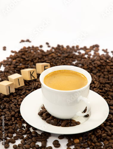 Coffee cup and beans close-up isolated on a white background.