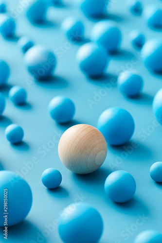 Wooden ball among blue spheres for singularity concept