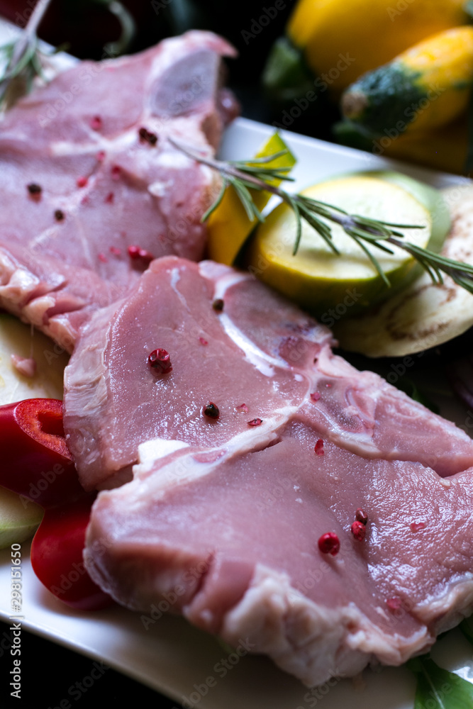 Fresh raw meat steak with vegetables close up Fresh raw meat steak with vegetables close up