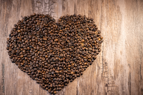 heart of coffee beans on wooden background