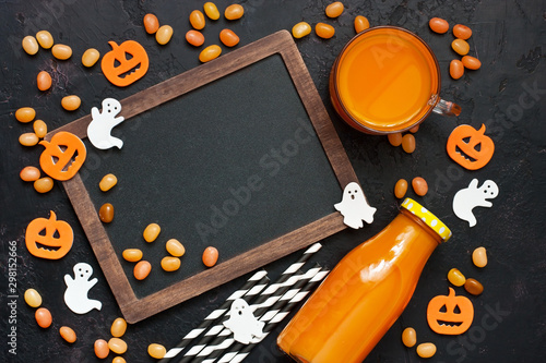 Top view at autumn drink for Halloween and colorful decorations on dark background