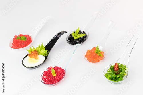 Molecular cuisine caviar elements shot closeup of a plastic buffet table spoon.