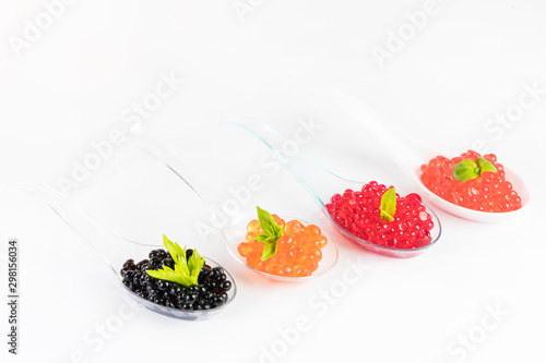 Fototapeta Naklejka Na Ścianę i Meble -  Molecular cuisine caviar elements shot closeup of a plastic buffet table spoon.