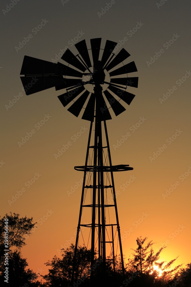 windmill at sunset with a colorful sky in Kansas north of Hutchinson. windmill at sunset with a colorful sky in Kansas north of Hutchinson.