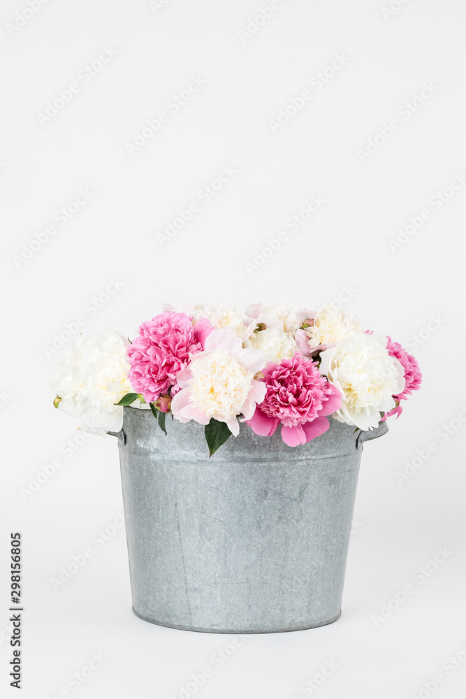 Bouquet of peonies in a metal bucket