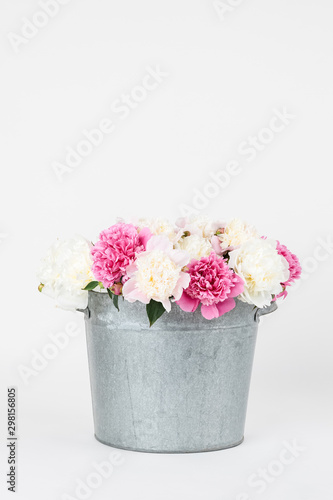 Bouquet of peonies in a metal bucket © megdypro4im