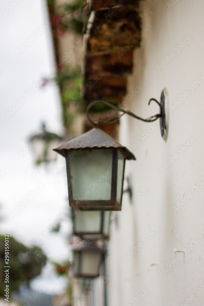 A sequence of wall lights in a white wall at the city of Paraty, Rio de Janeiro, world heritage in Brazil