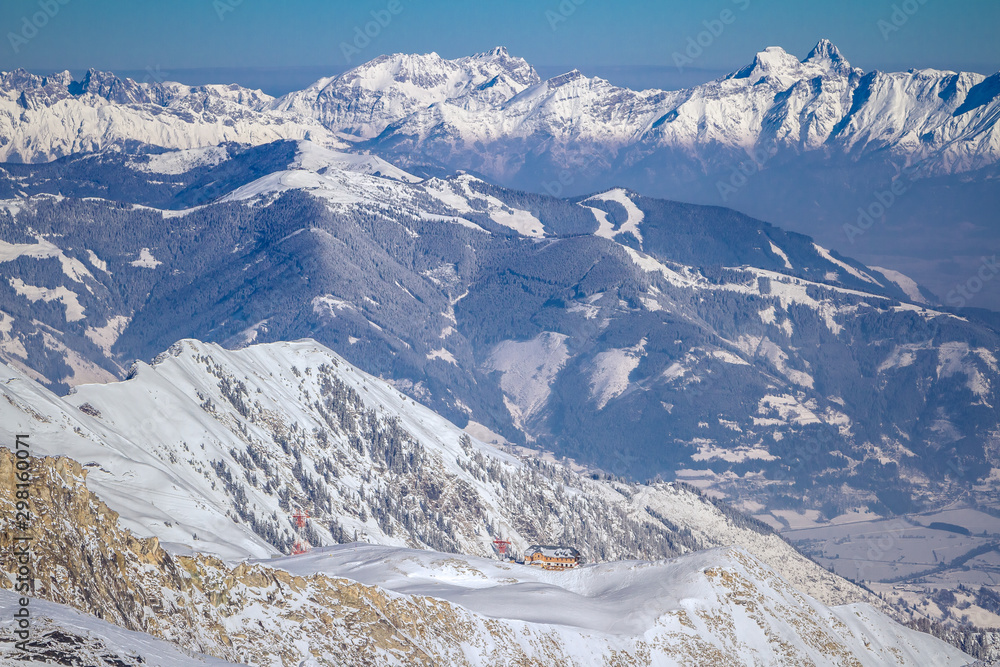 Winter landscape with snow covered slopes and blue sky from the top of Kitzsteinhorn mountain on . Kaprun ski resort, National Park Hohe Tauern, Austrian Alps Winter landscape with snow covered slopes and blue sky from the top of Kitzsteinhorn mountain on . Kaprun ski resort, National Park Hohe Tauern, Austrian Alps