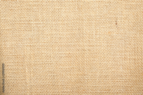 Hessian sackcloth burlap woven texture background / cotton woven fabric background with flecks of varying colors of beige and brown. with copy space. office desk concept.