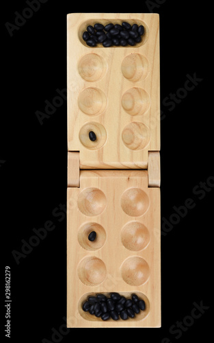 Stones and wooden folding board for playing mancala. photo