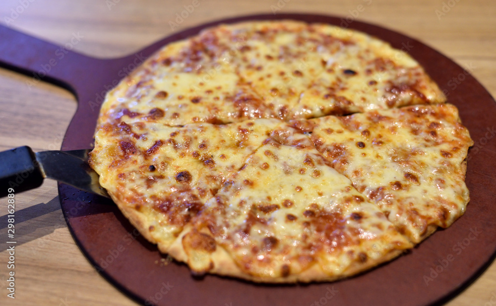 Hot pizza on wooden tray, Four cheese pizza