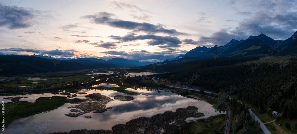 Aerial Panoramic View of a Scenic Road in a Beautiful Canadian Landscape during a colorful summer sunset. Taken in Kootenay near Golden, British Columbia, Canada.