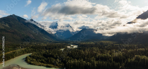 Aerial Panoramic View of Beautiful Canadian Mountain Landscape during a sunny and cloudy summer sunrise. Taken near Mt Robson, British Columbia, Canada.