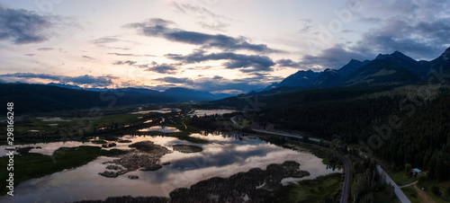 Aerial Panoramic View of a Scenic Road in a Beautiful Canadian Landscape during a colorful summer sunset. Taken in Kootenay near Golden, British Columbia, Canada.