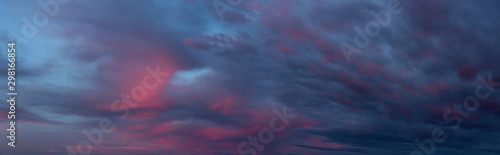 Fototapeta Naklejka Na Ścianę i Meble -  Dramatic Panoramic View of a cloudscape during a dark, rainy and colorful sunset. Taken in British Columbia, Canada.