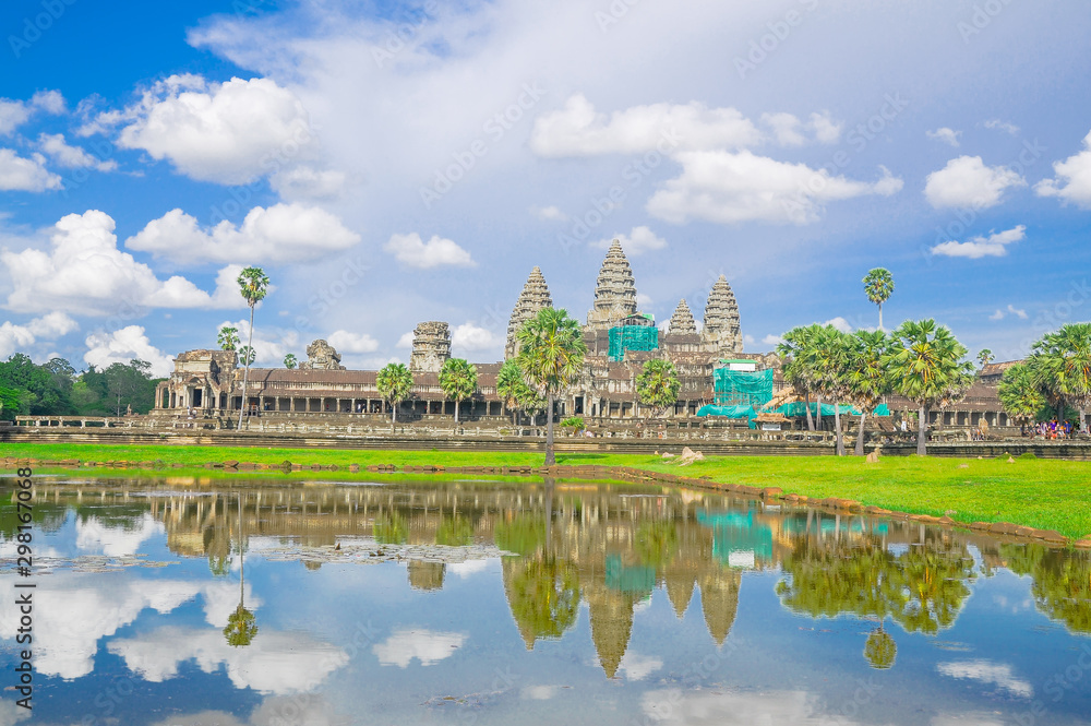 Reflection of Angkor Wat temple complex in Cambodia against cloud sky Reflection of Angkor Wat temple complex in Cambodia against cloud sky