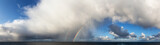 Dramatic Panoramic View of a cloudscape during a rainy and colorful morning with a bright double Rainbow. Taken over the Pacific Ocean in Alaska, USA.