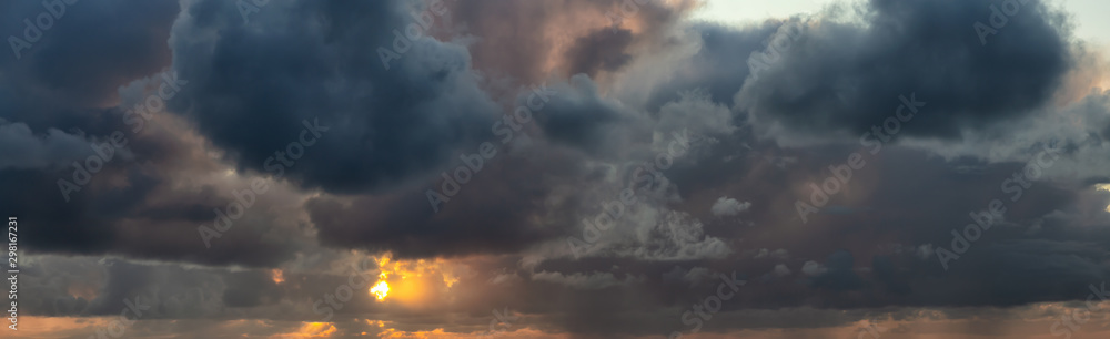 Dramatic Panoramic View of a cloudscape during a dark, rainy and colorful sunrise. Taken in Alaska, USA.
