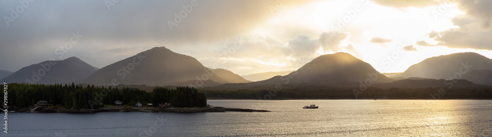 Beautiful Aerial Panoramic View of homes on the Ocean Coast during a dramatic stormy sunset. Taken in Ketchikan, Alaska, United States.