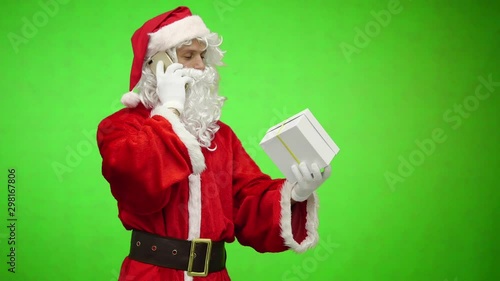 Santa Claus with gift talking on the phone. chromakey