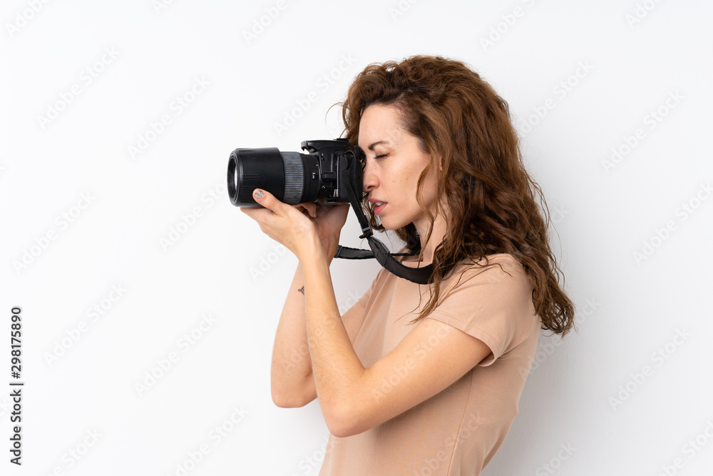 Young pretty woman over isolated background with a professional camera Young pretty woman over isolated background with a professional camera