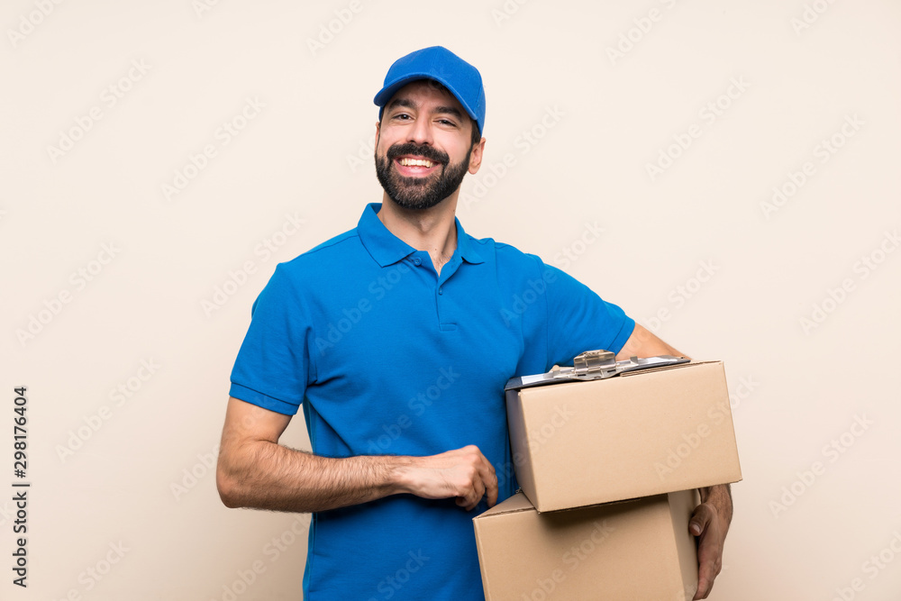 Delivery man with beard over isolated background keeping the arms crossed in frontal position Delivery man with beard over isolated background keeping the arms crossed in frontal position