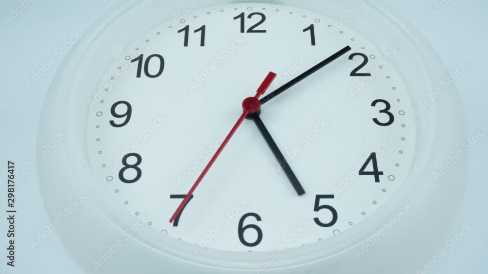 White wall clock face beginning of time 05.00 am or pm. on white background, Time lapse moving fast. White wall clock face beginning of time 05.00 am or pm. on white background, Time lapse moving fast.