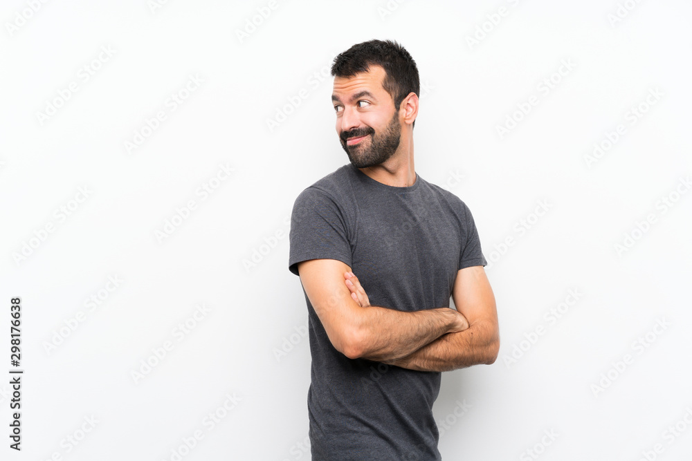 Young handsome man over isolated white background with arms crossed and happy Young handsome man over isolated white background with arms crossed and happy