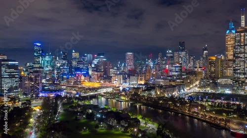 Aerial hyperlapse of night Melbourne CBD at Flinders Street in Melbourne along with Yarra River, Australia