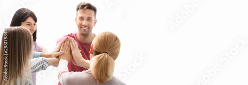 People putting hands togeth...