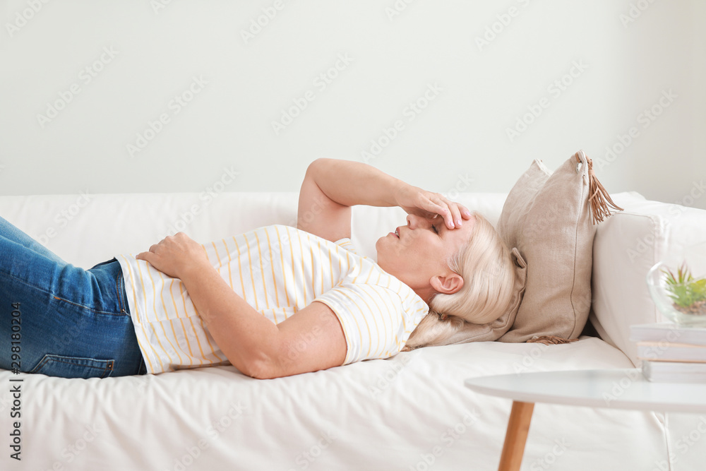 Mature woman suffering from headache at home Mature woman suffering from headache at home