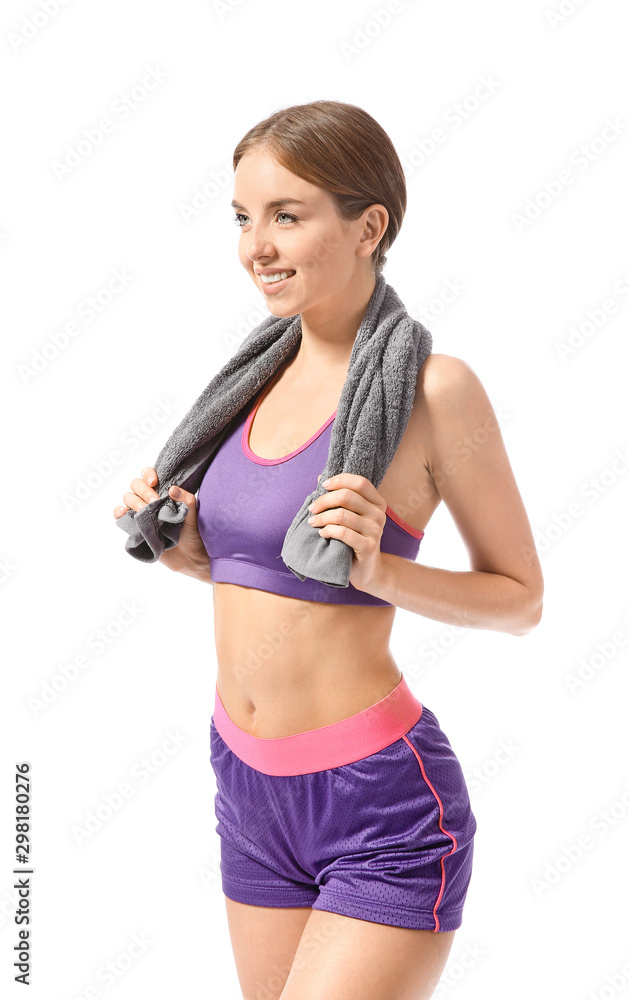 Sporty young woman with towel against white background Sporty young woman with towel against white background