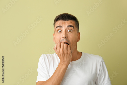 Shocked young man on color ...