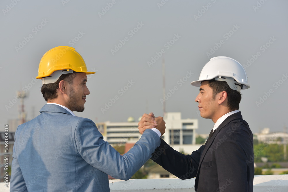 Business concept Engineers and technicians agree to work together to push. Business concept Engineers and technicians agree to work together to push.
