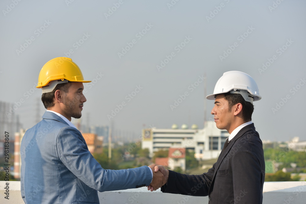 Business concept Engineers and technicians agree to work together to push. Business concept Engineers and technicians agree to work together to push.